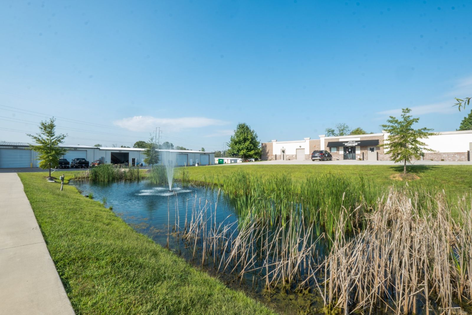 Retention pond with fountain in front of the storage buildings