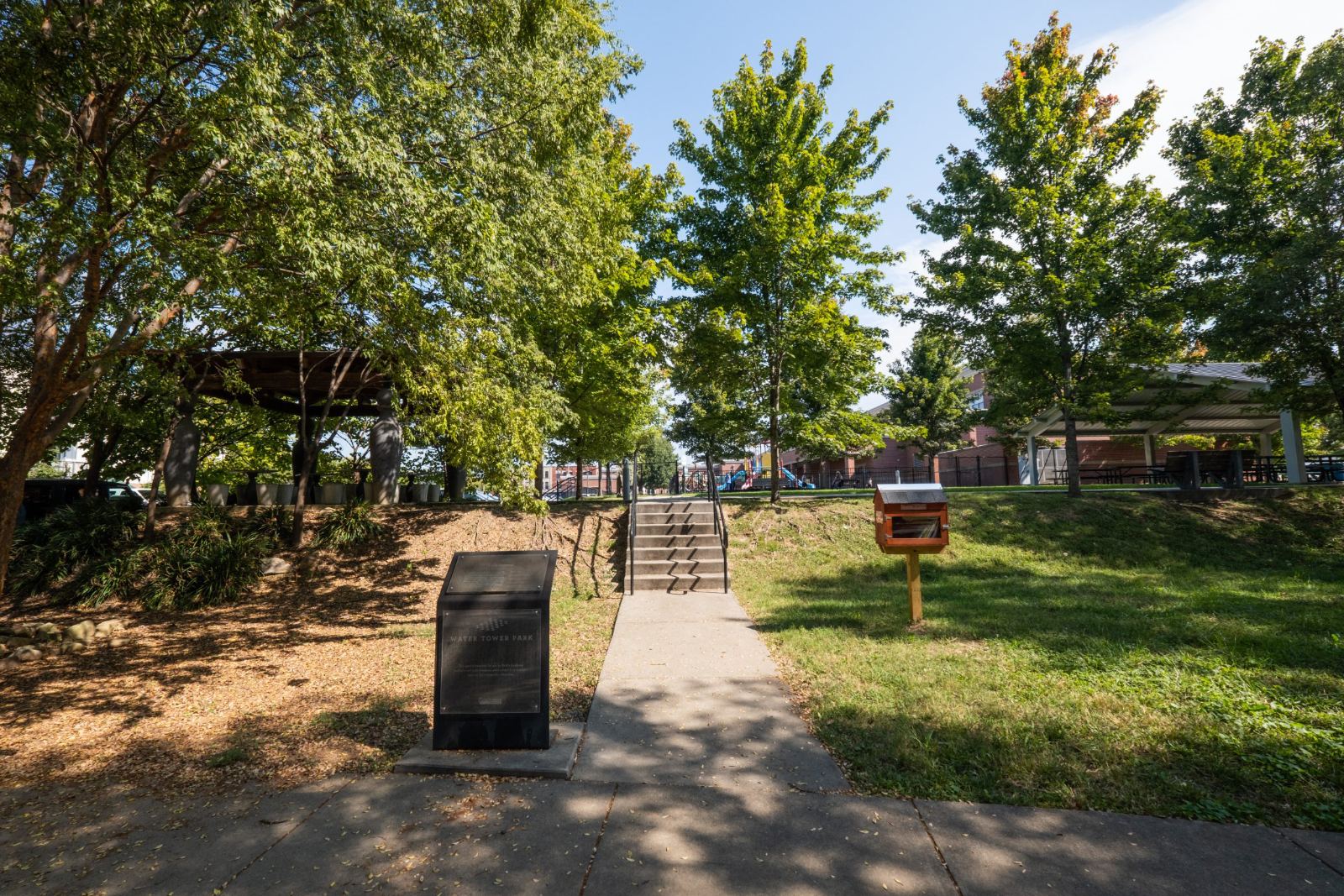 The 75-foot water tower rising above the park's grassy embankment